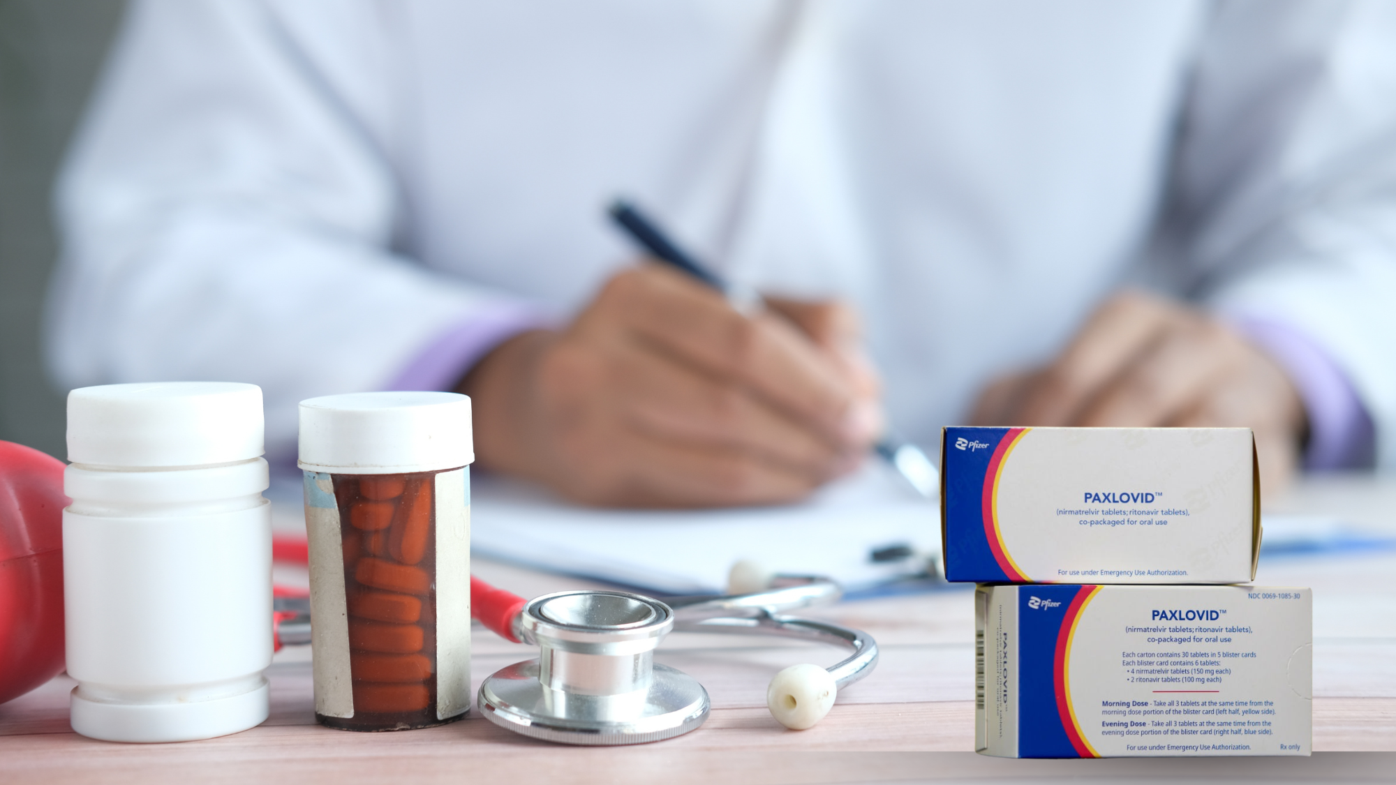 "Paxlovid rebound treatment — Paxlovid tablets, pill bottles, and stethoscope on doctor's desk with prescription being written"
