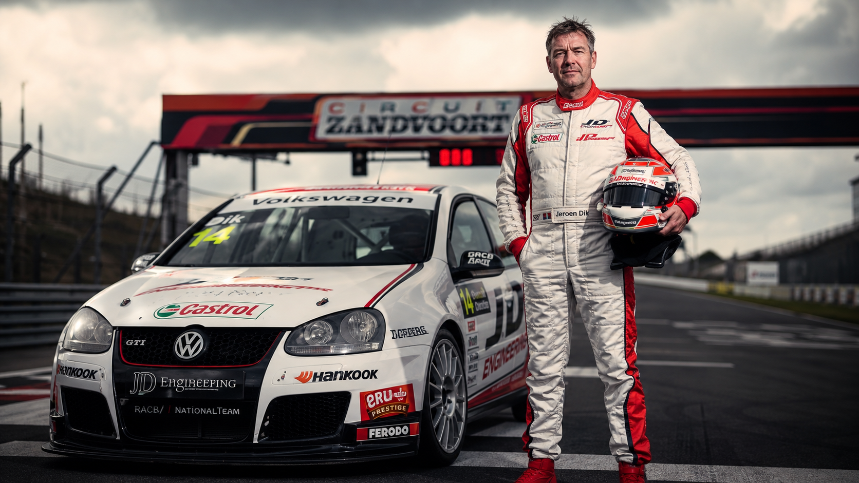 Race car driver Jeroen Dik standing in full racing gear beside his white Volkswagen Golf GTI at Circuit Zandvoort.